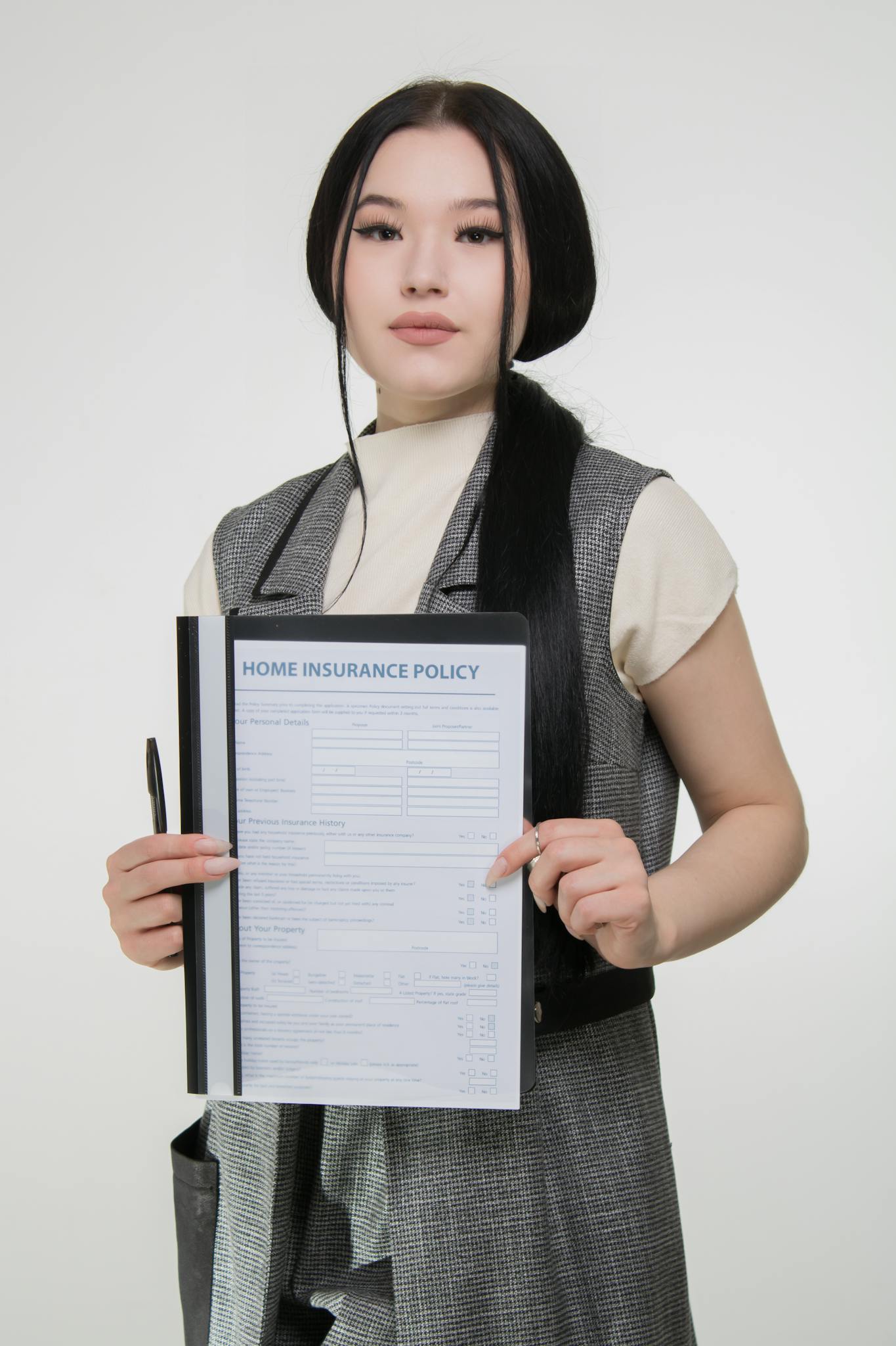 Confident woman holding a home insurance policy to showcase coverage details.